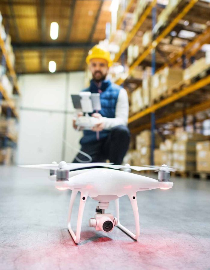 man-with-drone-in-a-warehouse-PMQEJ35.jpg